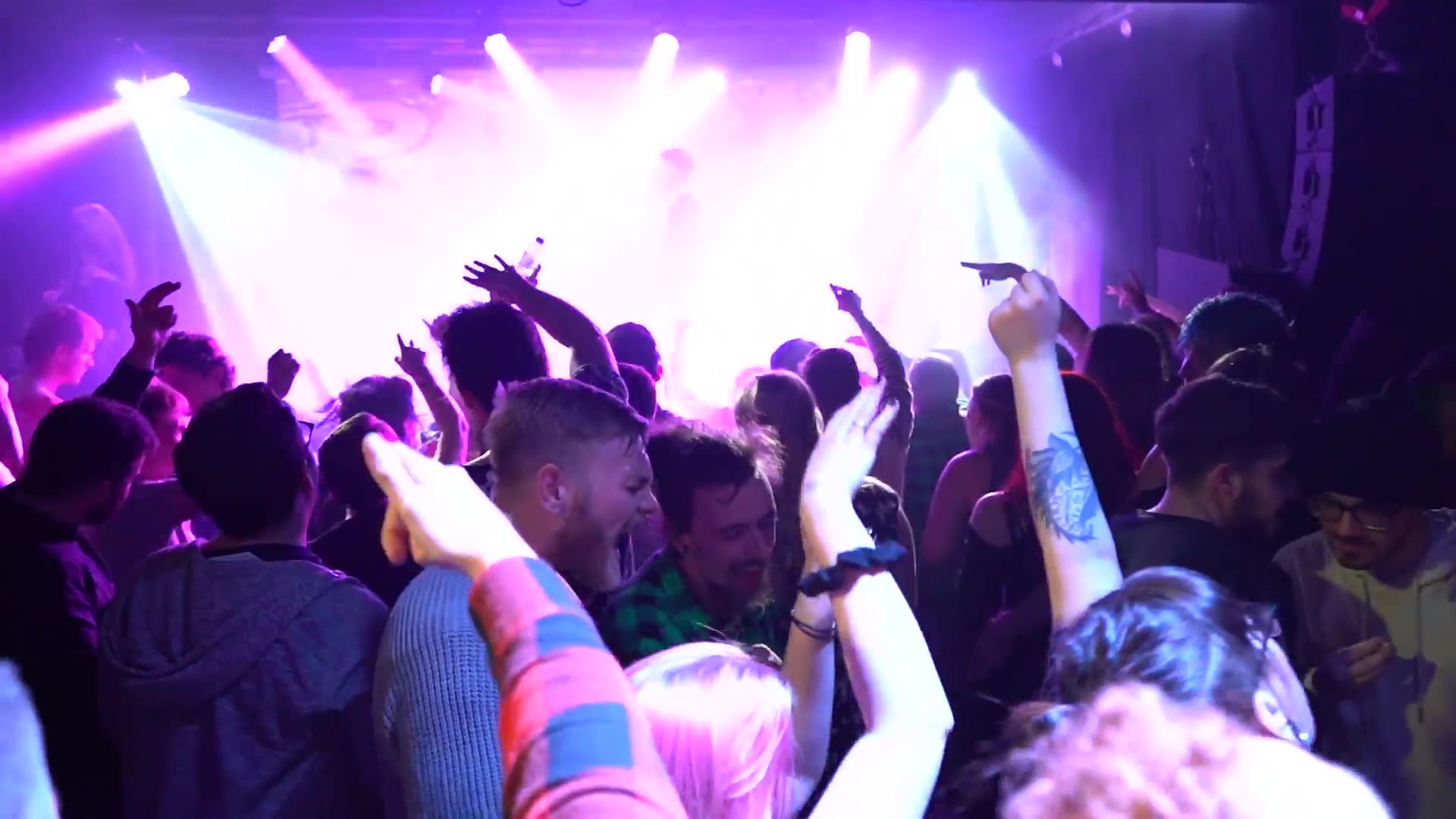 Hands up under the stage lights, the room packed